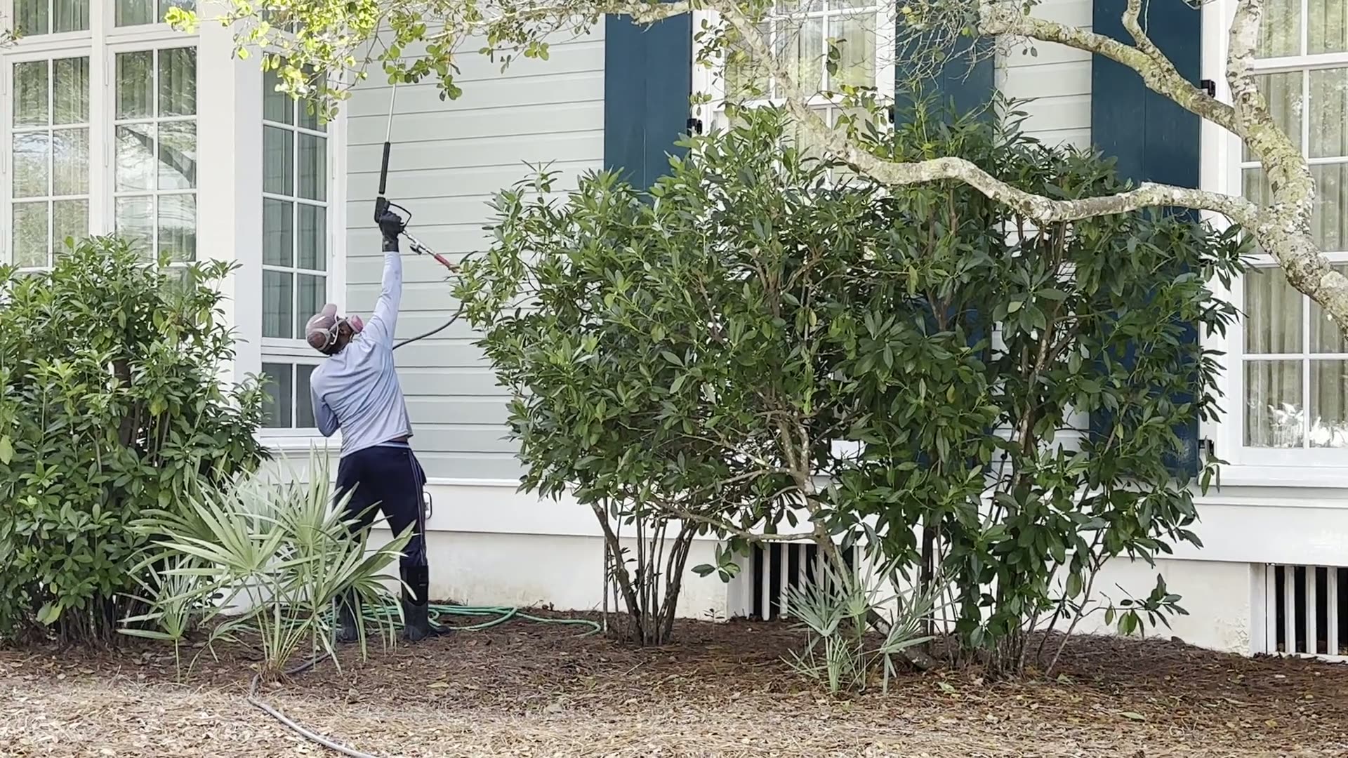 Chris Layne pressure washing the exterior of a coastal Florida home